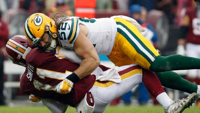 Green Bay Packers linebacker Clay Matthews (52) hits Washington Redskins quarterback Alex Smith (11) during the second half of an NFL football game, Sunday, Sept. 23, 2018 in Landover, Md. (AP Photo/Alex Brandon) ORG XMIT: FDX126