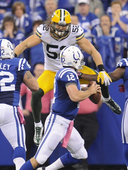 Packers linebacker Clay Matthews (52) leaps as he pressures Colts quarterback Andrew Luck (12) in the third quarter Oct. 7, 2012, at Lucas Oil Stadium in Indianapolis.