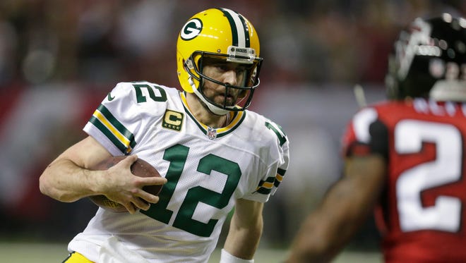 Green Bay Packers quarterback Aaron Rodgers scrambles during the third quarter.