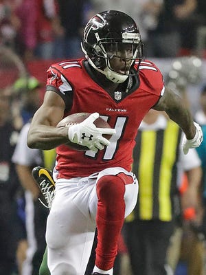Green Bay Packers cornerback LaDarius Gunter (36) misses the tackle and falls at the feet of wide receiver Julio Jones (11) on a long touchdown pass in the third quarter against the Atlanta Falcons at the Georgia Dome in Atlanta, Georgia Sunday, January 22, 2017.