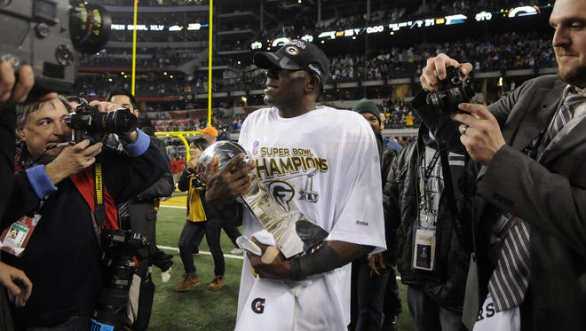 Packers receiver Donald Driver carries the Lombardi Trophy after the Packers defeated the Pittsburgh Steelers in Super Bowl XLV on Feb. 6, 2011, at Cowboys Stadium in Arlington, Texas.