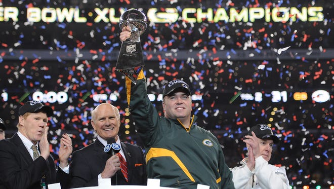 From left, Packers president/CEO Mark Murphy, Fox broadcaster Terry Bradshaw, Packers coach Mike McCarthy and Packers general manager Ted Thompson atop the podium with the Lombardi Trophy after Super Bowl XLV on Feb. 6, 2011, at Cowboys Stadium in Arlington, Texas.