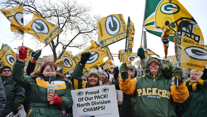 Green Bay Packers fans cheer during a pep rally in January 2014 at the Packers Heritage Trail Plaza in downtown Green Bay.