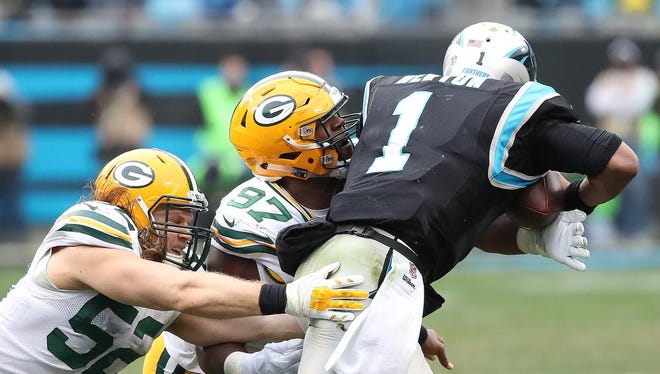 Green Bay Packers outside linebacker Clay Matthews (52) and nose tackle Kenny Clark (97) combine to sack Carolina Panthers quarterback Cam Newton (1) on Sunday, December 17, 2017 at Bank of America Stadium in Charlotte, N.C.