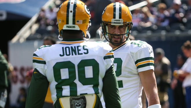 Quarterback Aaron Rodgers (12) of the Green Bay Packers talks with James Jones (89) during a 2015 game at Chicago.