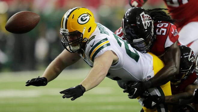 Green Bay Packers fullback Aaron Ripkowski (22) fumbles the ball after Atlanta Falcons' Jalen Collins forced the ball free during second quarter during the NFC Championship game Sunday, January 22, 2017, at the Georgia Dome in Atlanta, Ga. Atlanta Falcons outside linebacker Sean Weatherspoon (56) is in on the play.