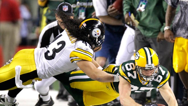 Green Bay Packers receiver Jordy Nelson stretches out a reception past Pittsburgh Steelers safety Troy Polamalu in the first half of Super Bowl XLV.
