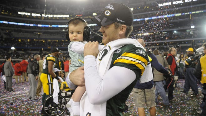 Green Bay Packers kicker Mason Crosby holds his son Nolan after the Packers' victory over the Pittsburgh Steelers in Super Bowl XLV on Feb. 6, 2011, at Cowboys Stadium in Arlington, Texas.