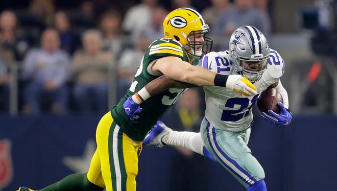 Green Bay Packers linebacker Clay Matthews tackles Dallas Cowboys running back Ezekiel Elliott during the Packers's 34-31 victory in the NFC playoffs last January.