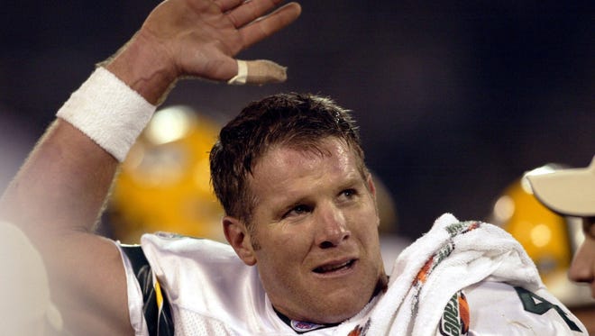 Brett Favre waves to his wife, Deanna, in a luxury box after throwing his fourth touchdown pass against the Oakland Raiders.