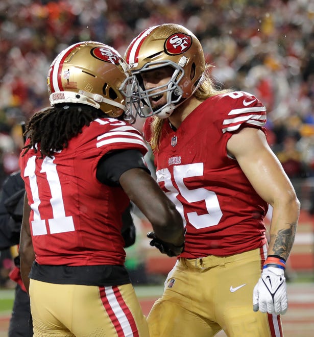 San Francisco 49ers tight end George Kittle (85) celebrates his touchdown reception with wide receiver Brandon Aiyuk (11) against the Green Bay Packers during their NFC divisional playoff football game Saturday, January 20, 2024, at Levi's Stadium in Santa Clara, California.