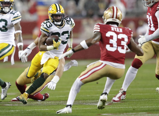 Green Bay Packers running back Aaron Jones (33) runs for a gain againsts the San Francisco 49ers during their NFC divisional playoff football game Saturday, January 20, 2024, at Levi's Stadium in Santa Clara, California.