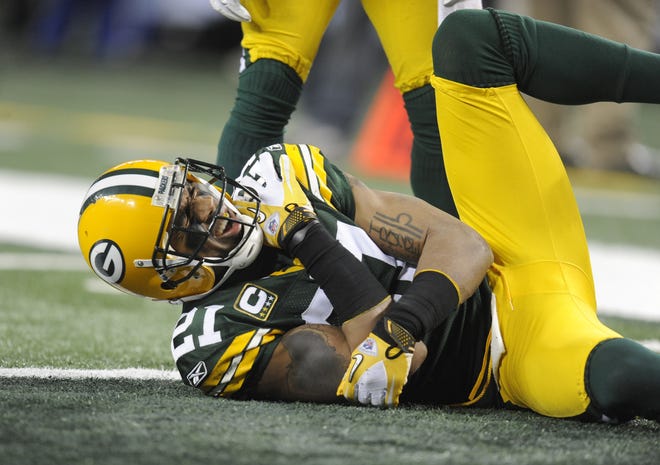 Green Bay Packers cornerback Charles Woodson grimaces in pain after injuring his shoulder in the second quarter against the Pittsburgh Steelers in Super Bowl XLV at Cowboys Stadium in Arlington, Texas, on Feb. 6, 2011.