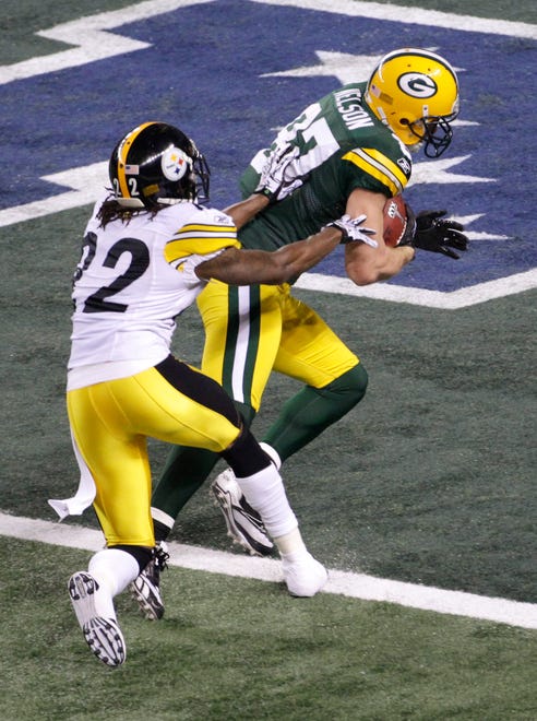 The Green Bay Packers receiver Jordy Nelson (87) crosses the goal line after catching a pass for a touchdown from quarterback Aaron Rodgers and in the first quarter against the Pittsburgh Steelers cornerback William Gay (22), in Super Bowl XLV, in Arlington, Texas, Sunday, February 6, 2011.