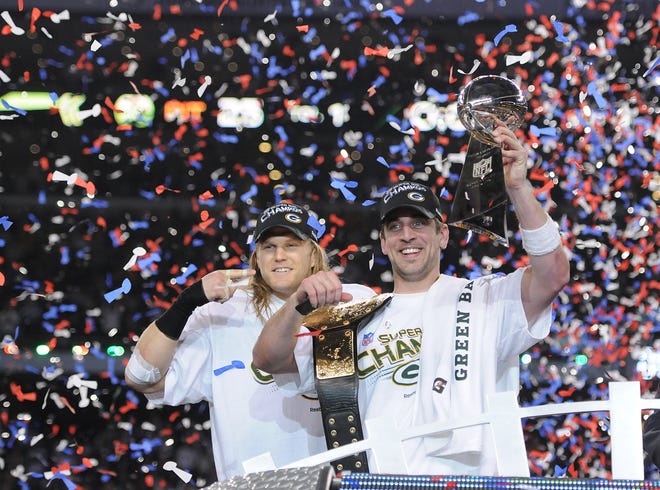 2010 SEASON: Green Bay Packers linebacker Clay Matthews, left, points to Super Bowl MVP Aaron Rodgers after giving him a championship belt after the win against the Pittsburgh Steelers during Super Bowl XLV at Cowboys Stadium in Arlington, Texas on Feb. 6, 2011.