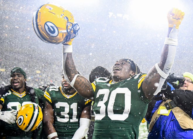 Green Bay Packers running back Jamaal Williams (30) celebrates after the Packers defeated the Carolina Panthers at Lambeau Field.