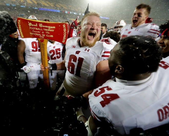 Wisconsin center Tyler Biadasz, holding Paul Bunyan's Axe, will likely be playing his final game for the Badgers in the Rose Bowl.