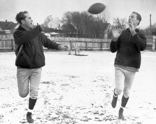 The talented passing combination of halfback Cecil Isbell (left) and end Don Hutson of the Green Bay Packers caused the Chicago Bears plenty of trouble when the two teams met on Sunday, Dec. 14, 1941, in Chicago for the Western Division Playoff of the National Professional Football League.  The two conditioned themselves for any weather as they practiced their famous tricks on a snow covered field at Green Bay.