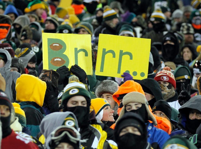 Fans hold a sign illustrating the cold during the 4th quarter of the Packers 20-23 loss to the San Francisco 49ers at Lambeau Field on Sunday, January 5, 2014.