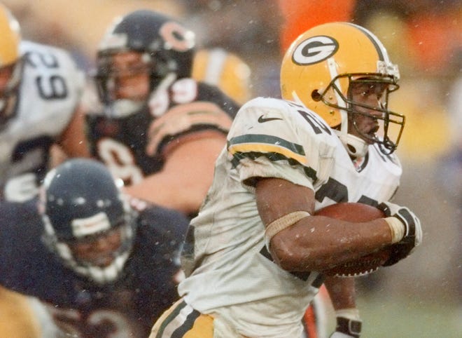 Green Bay Packers rookie running back De'Mond Parker races past Chicago Bears defenders Warrick Holdman and Jim Flanigan (99) for a 21-yard touchdown on Sunday, Dec. 5, 1999, in Chicago. Parker had two fourth quarter touchdowns to lead the Packers to a 35-19 win.