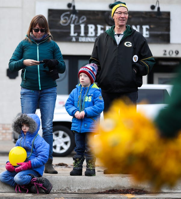 Nora Nimmer, left, 7, Heather Nimmer, middle, Grant Nimmer, 4, and Jeff Mirkes listen to speakers during the pep rally on Friday, January 10, 2020, at Packers Heritage Trail in Green Bay, Wis. Ebony Cox/USA TODAY NETWORK-Wisconsin