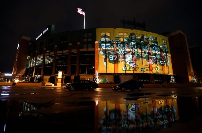 An image of Green Bay Packers playersis projected on the west side of Lambeau Field on Thursday ahead of the team's home playoff against the Seattle Seahawks in Green Bay.