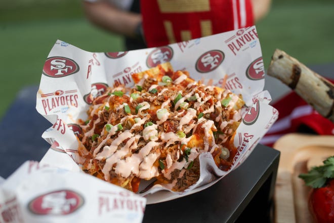 Nachos topped with pulled Korean barbecue pork, jalapeño cheese sauce, kimchi, green onion, and gochujang crema is part of the special playoff menu at Levi's Stadium for the 49ers and Packers NFC Championship game in Santa Clara, Calif.