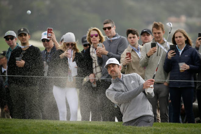 Aaron Rodgers hits out of a bunker onto the sixth green of the Pebble Beach Golf Links during the third round of the AT&T Pebble Beach National Pro-Am golf tournament Saturday, Feb. 8, 2020, in Pebble Beach, Calif.