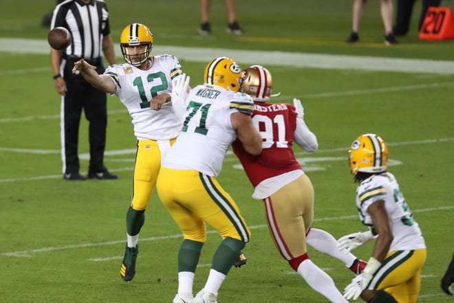 Green Bay Packers quarterback Aaron Rodgers (12) passes against the San Francisco 49ers during the first half of an NFL football game in Santa Clara, Calif., Thursday, Nov. 5, 2020.