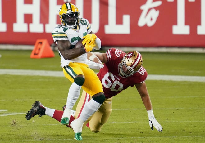 Green Bay Packers safety Raven Greene (24) returns an intercepting against San Francisco 49ers offensive guard Daniel Brunskill (60) during the second quarter at Levi's Stadium.
