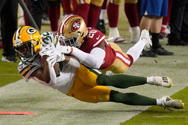 Green Bay Packers running back Tyler Ervin (32) is tackled by San Francisco 49ers free safety Jimmie Ward (20) during the first half of an NFL football game in Santa Clara, Calif., Thursday, Nov. 5, 2020.