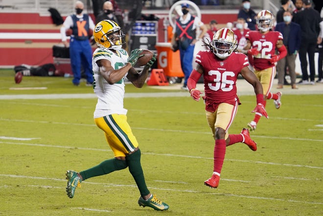 Green Bay Packers wide receiver Marquez Valdes-Scantling (83) catches a pass to score a touchdown against San Francisco 49ers safety Marcell Harris (36) during the second quarter at Levi's Stadium.