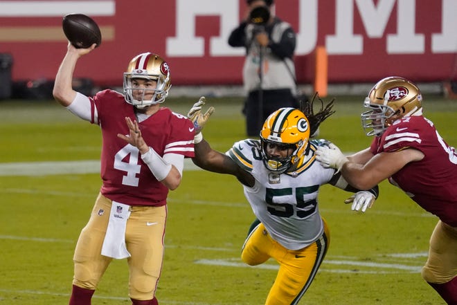 San Francisco 49ers quarterback Nick Mullens (4) passes in front of Green Bay Packers outside linebacker Za'Darius Smith (55) during the second half of an NFL football game in Santa Clara, Calif., Thursday, Nov. 5, 2020.