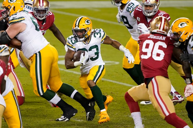 Green Bay Packers running back Aaron Jones (33) runs against the San Francisco 49ers during the first half of an NFL football game in Santa Clara, Calif., Thursday, Nov. 5, 2020.