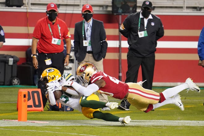 Green Bay Packers running back Tyler Ervin (32) runs the ball to the first down marker against San Francisco 49ers free safety Jimmie Ward (20) during the second quarter at Levi's Stadium.