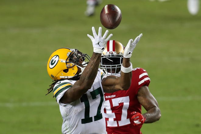 Green Bay Packers wide receiver Davante Adams (17) catches a pass in front of San Francisco 49ers cornerback Jamar Taylor (47) during the second half of an NFL football game in Santa Clara, Calif., Thursday, Nov. 5, 2020.