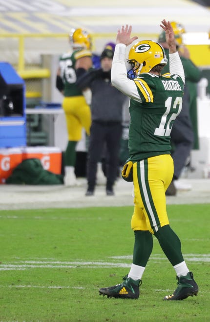 Green Bay Packers quarterback Aaron Rodgers (12) gets the crowd pumped up during the 4th quarter of the Green Bay Packers 32-18 win over the Los Angeles Rams during the NFC divisional playoff game Saturday, Jan. 16, 2021, at Lambeau Field in Green Bay, Wis.
