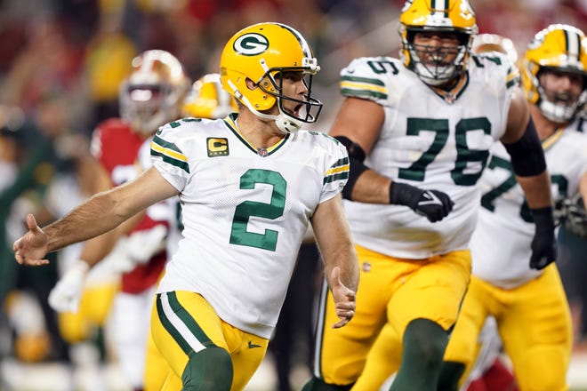 Green Bay Packers kicker Mason Crosby (2) celebrates after kicking a game-winning field goal during the fourth quarter Sunday night.