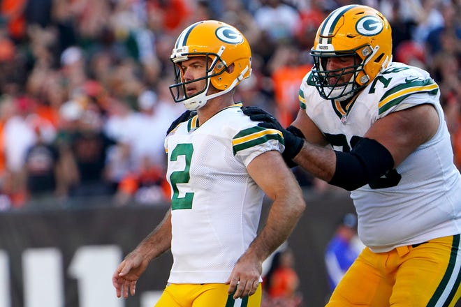 Green Bay Packers guard Jon Runyan (76) congratulates Green Bay Packers kicker Mason Crosby (2) after kicking a game-winning field goal in overtime of a Week 5 NFL football game against the Cincinnati Bengals, Sunday, Oct. 10, 2021, at Paul Brown Stadium in Cincinnati. The Green Bay Packers won, 25-22.