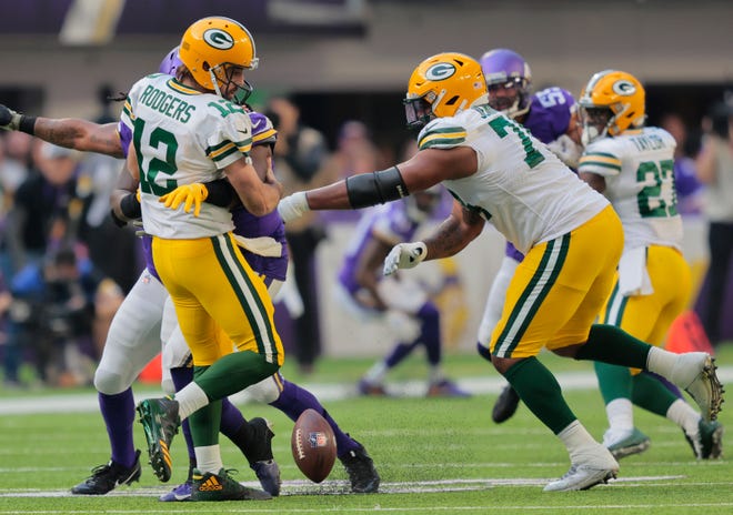 Green Bay Packers quarterback Aaron Rodgers (12) fumbles the ball as he is sacked by Minnesota Vikings defensive tackle Armon Watts (96) in the first quarter during their football game Sunday, November 21, 2021, at U.S. Bank Stadium in Minneapolis.