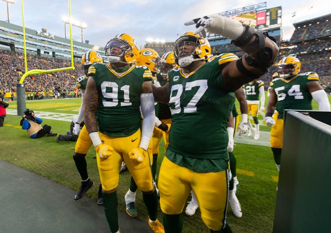 Green Bay Packers outside linebacker Preston Smith (91) celebrates his fumble recovery during the first quarter of their game Sunday, Nov. 28, 2021 at Lambeau Field in Green Bay. The Green Bay Packers beat the Los Angeles Rams 36-28.