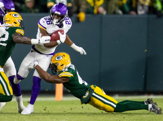 Minnesota Vikings running back Kene Nwangwu (26) is tackled by Green Bay Packers safety Henry Black (41) in the first quarter, Sunday, January 2, 2022, at Lambeau Field in Green Bay, Wis. Samantha Madar/USA TODAY NETWORK-Wisconsin