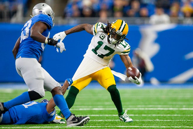 Jan 9, 2022; Detroit, Michigan, USA; Green Bay Packers wide receiver Davante Adams (17) gets his jersey grabbed by Detroit Lions free safety Tracy Walker III (21) during the second quarter at Ford Field.