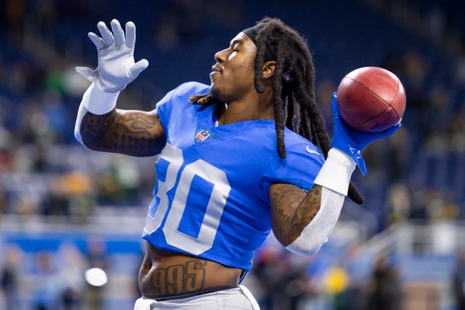 Jan 9, 2022; Detroit, Michigan, USA; Detroit Lions running back Jamaal Williams (30) plays catch with the fans before the game against the Green Bay Packers at Ford Field.