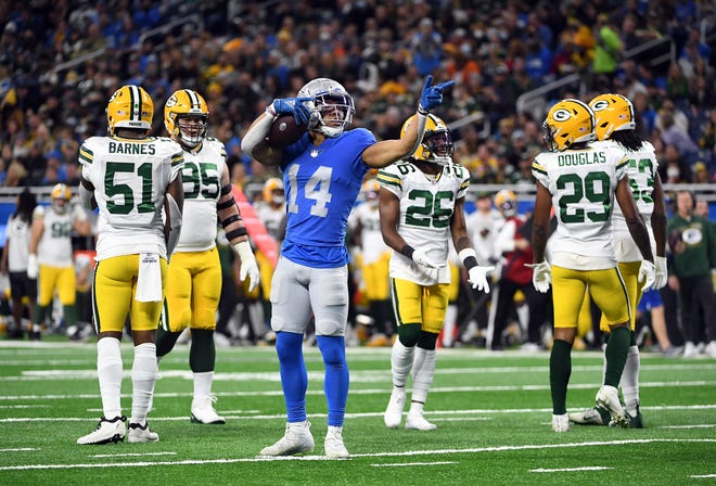 DETROIT, MICHIGAN - JANUARY 09: Amon-Ra St. Brown #14 of the Detroit Lions reacts after a first down reception against the Green Bay Packers during the second quarter at Ford Field on January 09, 2022 in Detroit, Michigan.