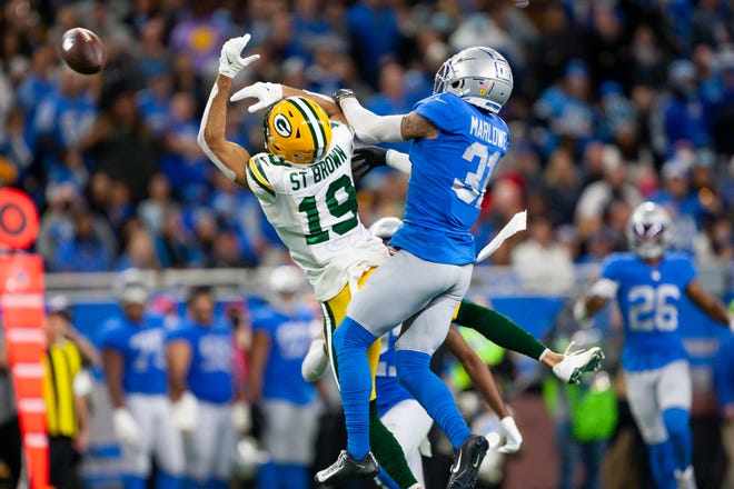 Jan 9, 2022; Detroit, Michigan, USA; Detroit Lions safety Dean Marlowe (31) breaks up a pass intended for Green Bay Packers wide receiver Equanimeous St. Brown (19) during the fourth quarter at Ford Field. Mandatory Credit: Raj Mehta-USA TODAY Sports