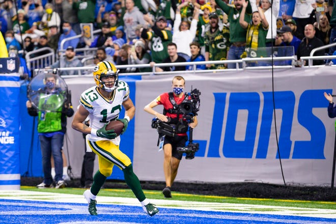 Jan 9, 2022; Detroit, Michigan, USA; Green Bay Packers wide receiver Allen Lazard (13) makes a touchdown reception during the first quarter against the Detroit Lions at Ford Field.