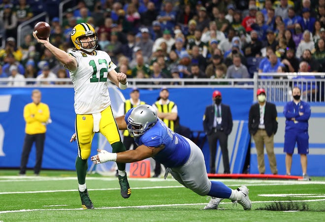 DETROIT, MICHIGAN - JANUARY 09: Aaron Rodgers of the Green Bay Packers throws a pass during the first quarter against the Detroit Lions at Ford Field on January 09, 2022 in Detroit, Michigan.