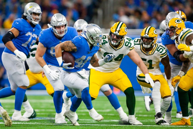 Jan 9, 2022; Detroit, Michigan, USA; Green Bay Packers defensive end Dean Lowry (94) pursues Detroit Lions running back Craig Reynolds (46) during the second quarter at Ford Field.