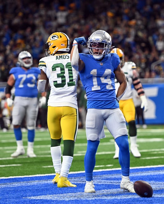 DETROIT, MICHIGAN - JANUARY 09: Amon-Ra St. Brown #14 of the Detroit Lions celebrates after scoring a touchdown against the Green Bay Packers during the second quarter at Ford Field on January 09, 2022 in Detroit, Michigan.